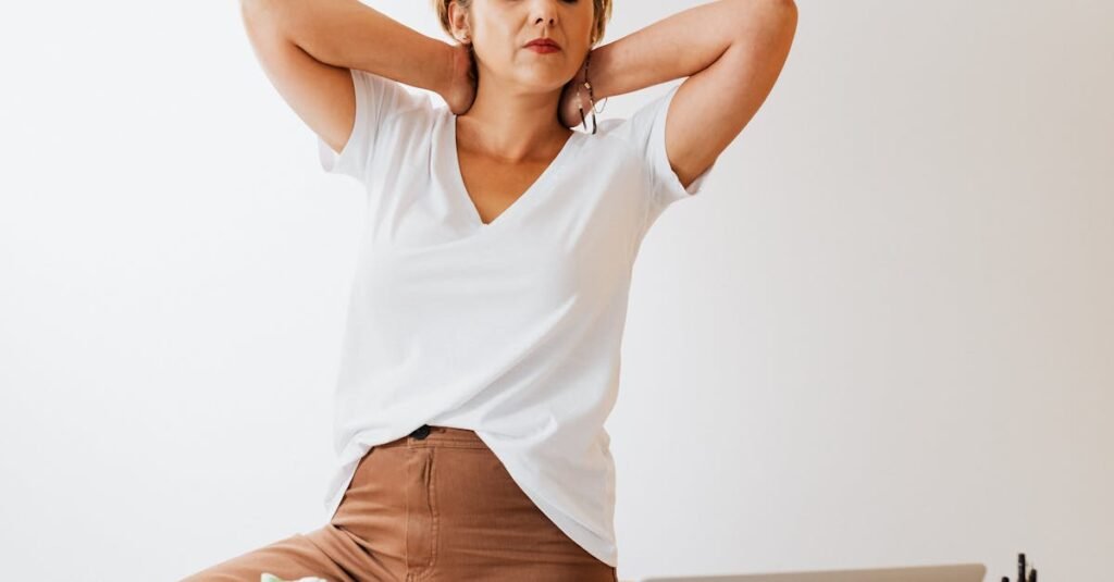 A woman in modern office setup takes a stretch break, embodying relaxed workplace culture.
